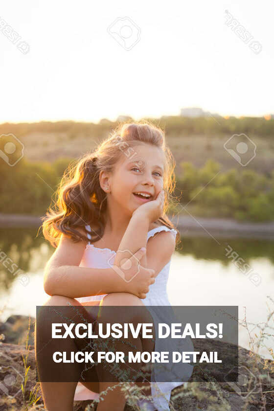 A Small Smiling Girl With Curly Brown Hair Dressed White Short ...