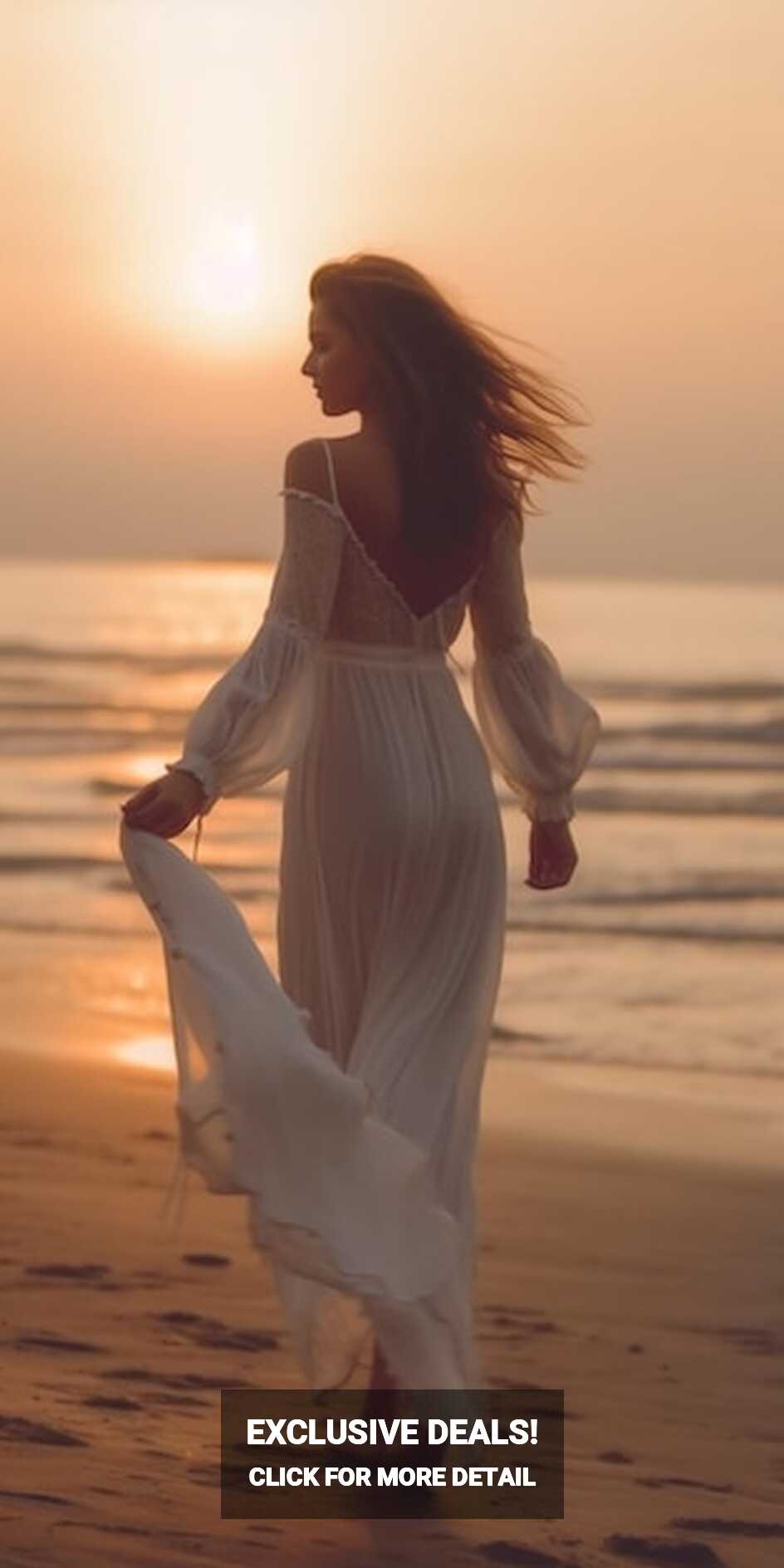 Premium Photo | A woman in a white dress walks on the beach at sunset.