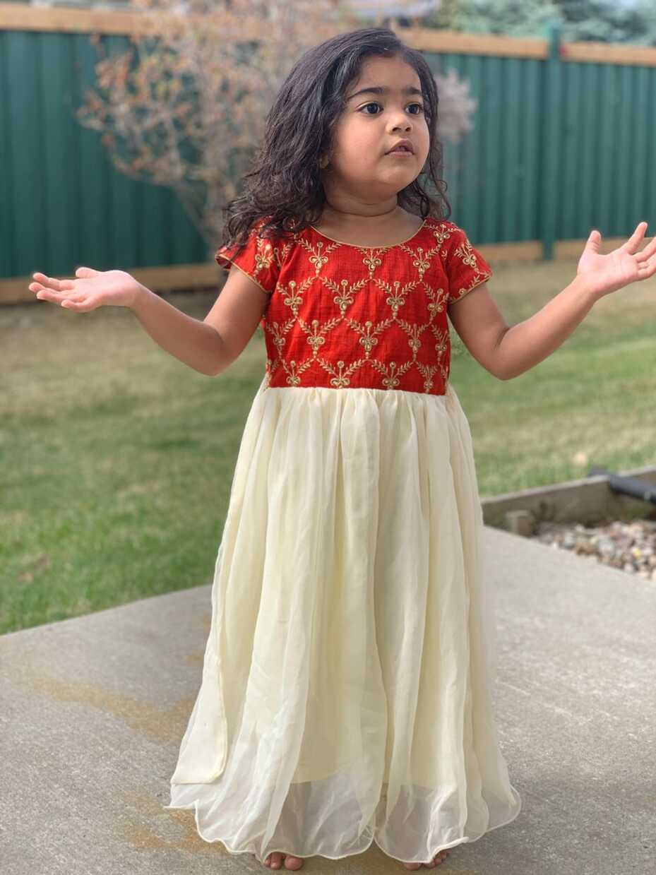 Baby in red and white georgette long frock