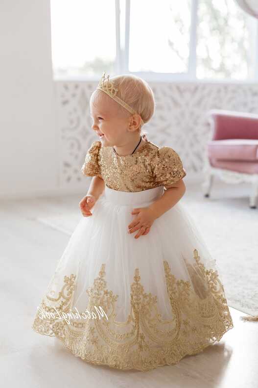 Gold baby girl princess dress with sequins and lace trim on tutu botto