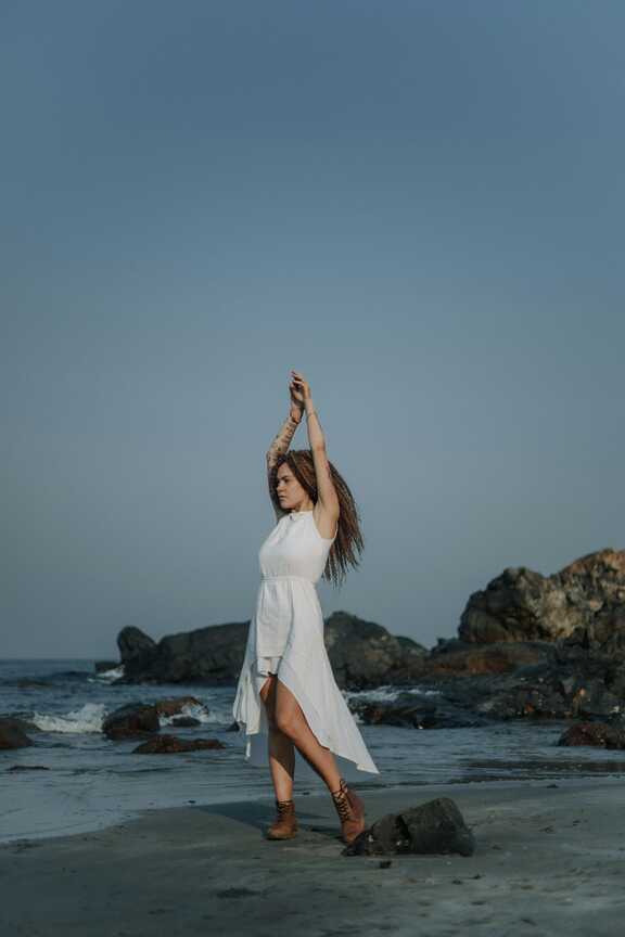 Model Posing in White Dress on a Beach · Free Stock Photo