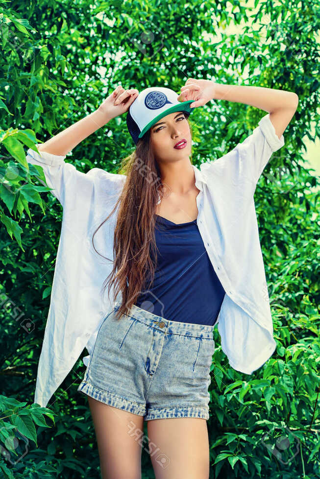 Modern Girl Wearing Casual Clothes And A Cap Posing Outdoor ...