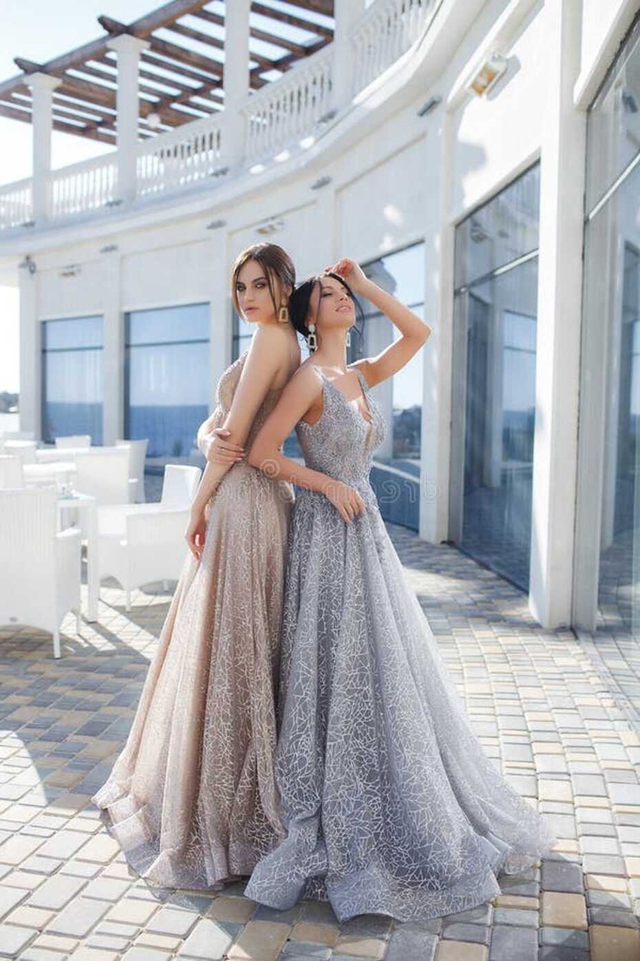 Two Beautiful Women, Models, Demonstrate Evening Dresses for ...